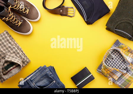 Mens fall casual clothing outfits and accessories flat lay on yellow background, top view Stock Photo