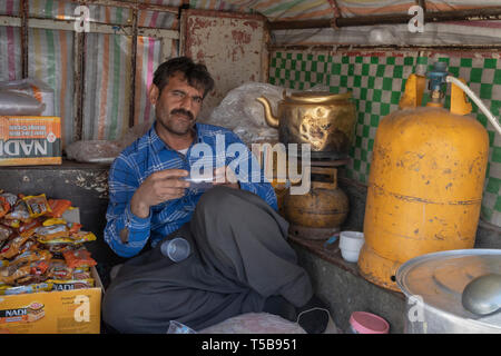Smuggler Selling Tea Inside Car In Winter At Roadside Bazaar In Uraman Valley, Kurdistan Province, Iran