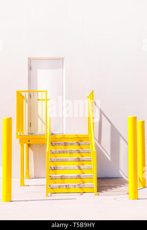 Bright yellow staircase and a white wall Stock Photo