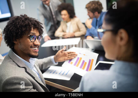 Image of business partners discussing documents and ideas Stock Photo