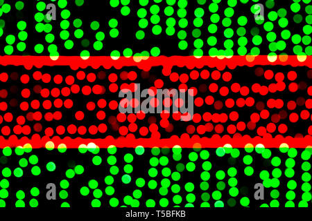 Unfocused abstract green and red bokeh on black background. defocused and blurred many round light. Stock Photo