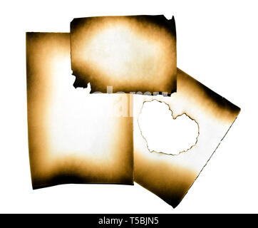 Burned paper collage with heart in burned hole on white background with clipping path Stock Photo
