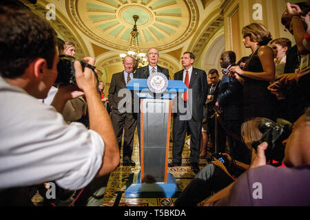 Senate Minority Leader Mitch McConnel (R-Ky) speaks to the media about the proposal from the so-called 'Gang of Six' during the ongoing debt negitoations in July 2011. Behind McConnel is US Senator Lamar Alexander (R-Tn) and US Senator John Barasso (R-Wy) Stock Photo