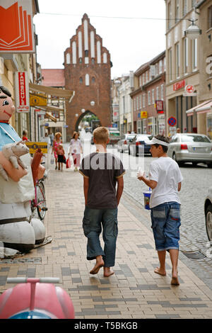 two teenage boys walking barefoot through the centre of Teterow ...