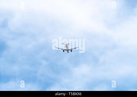 Passenger Airplane flying on cloudy sky. Airline, airliner Stock Photo