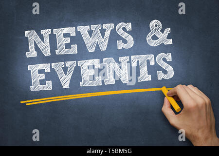 hand writing chalk text on blue chalkboard - news and events Stock Photo