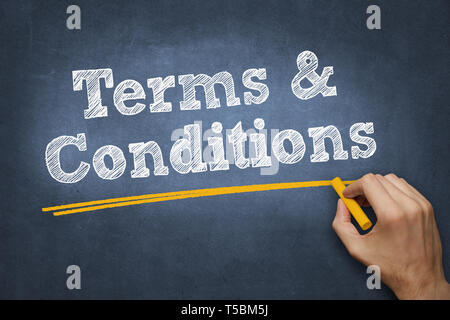 hand writing chalk text on blackboard - terms and conditions Stock Photo