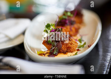Close up of deep fried hard boiled eggs with a jelly topping and shallow depth of field Stock Photo