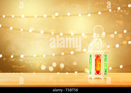 Arabic lamp with beautiful light on wooden table with blurry lights background Stock Photo