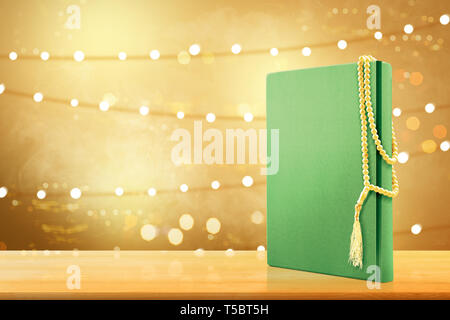 Quran and prayer beads on wooden table with blurry lights background Stock Photo