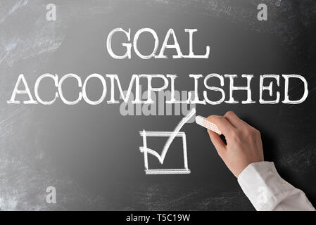 words GOAL ACCOMPLISHED with checkmark on blackboard Stock Photo