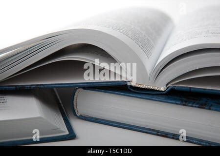 open books with other books on a gray table close up Stock Photo