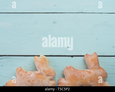 Sweet Easter bunnies on a rustic wooden background Stock Photo