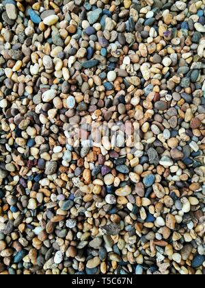 colourful aggregate stone gravel. construction materials for dirt ground cover. multi colour round river gravel for garden decoration. landscape archi Stock Photo