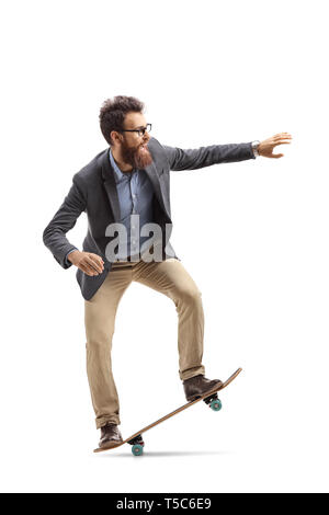 Full length shot of a bearded man in formal clothes riding a skateboard isolated on white background Stock Photo