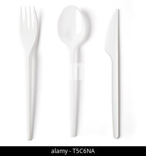 Disposable plastic cutlery fork, spoon and knife with working pats isolated on white. Stock Photo