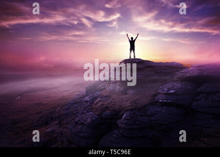 A man expressing freedom by reaching up to the sky as the sun sets in the distance. Hopes and dreams photo composite.