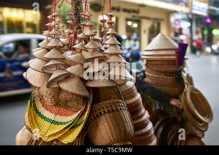 Street seller with asian conical wooden hats and baskets Stock Photo