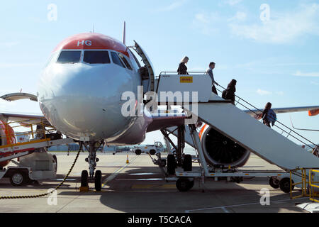 Front side view of passengers getting off leaving an Easyjet aircraft plane on the tarmac at Bristol Airport England UK Great Britain  KATHY DEWITT Stock Photo