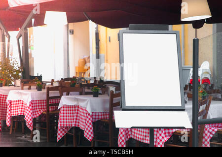 Italian street restaurant with blank menu board on a stand Stock Photo