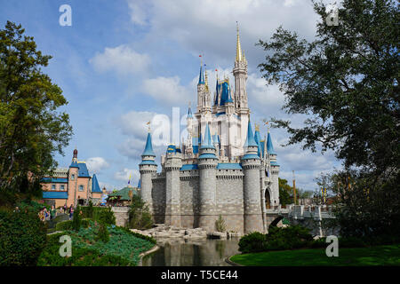 Orlando, FL/USA - 02/07/18: A side horizontal view of Cinderellas Castle framed by trees at Disney World in Orlando, Florida  on a beautiful sunny day. Stock Photo