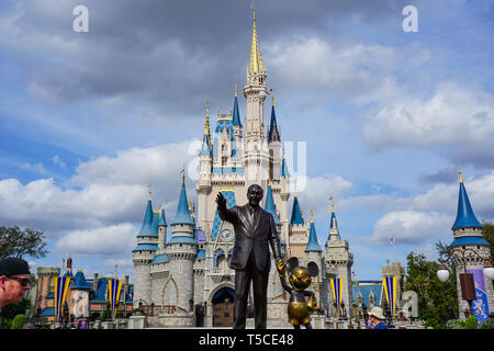 Orlando, FL/USA - 02/07/18: Walt Disney and Mickey Mouse Partners statue in front of Cinderellas Castle at Disney World's Magic Kingdom. Stock Photo