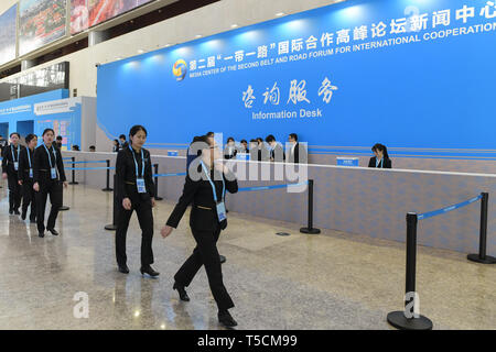 (190423) -- BEIJING, April 23, 2019 (Xinhua) -- Staff members walk pass the Information Desk of the Media Service Area in the Media Center for the second Belt and Road Forum for International Cooperation in Beijing, capital of China, on April 23, 2019. The media center started trial operation at the China National Convention Center in Beijing Tuesday. More than 4,100 journalists, including 1,600 from overseas, have registered to cover the second Belt and Road Forum for International Cooperation to be held from April 25 to 27 in Beijing. (Xinhua/Li He) Stock Photo