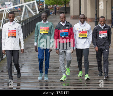 London, UK. 24th April, 2019. Elite Men marathon athletes take part in a photocall at the Tower Hotel before the London Marathon on Sunday 28th April. Image: Tola (ETH), Kiptum (KEN), Farah (GBR), Kipchoge (KEN) and Kitata (ETH). Credit: Malcolm Park/Alamy Live News. Stock Photo