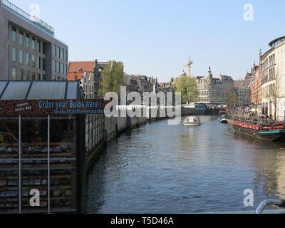 Covered stalls line the Singel Canal, home to the Bloemenmarkt or Amsterdam's floating flower market Stock Photo