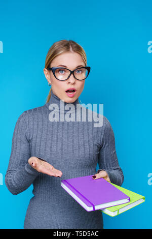 Image of serious woman in glasses with notebook in hands Stock Photo