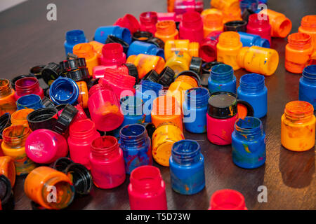 a lot of different paint cans opened on a mountain Stock Photo