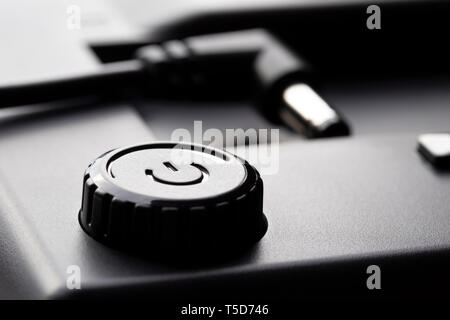 Black plastic power on off button with power adjustment. 12 volt plug. The concept of modern technology. Stock Photo