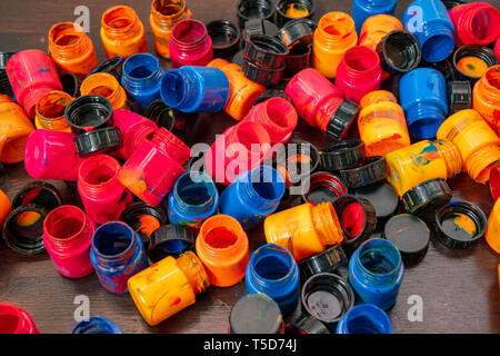 a lot of different paint cans opened on a mountain Stock Photo