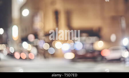 Blurred New York city street at night, color toned urban abstract background. Stock Photo