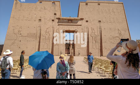 Visitors approach the  the 3rd century BCE Temple of Horus, in Edfu, Egypt. Stock Photo