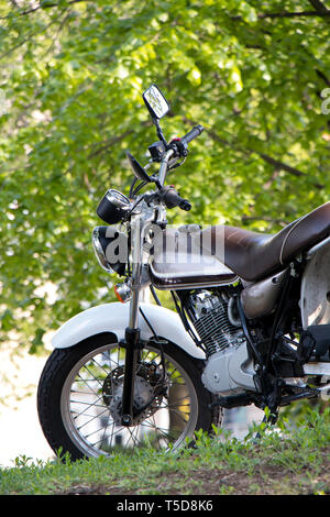 Parked vintage elegant motorbike in spring nature background, low angle view Stock Photo