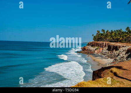 Beach with palm trees in Varkala in India Stock Photo