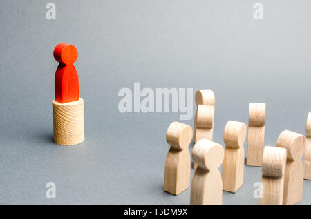 Red man stands on the podium and appeals to the crowd of people. Agitation, appeal and appeal to the crowd. Leader and leadership qualities, political Stock Photo