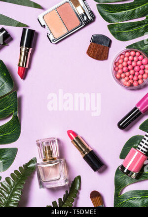 Makeup professional cosmetics on purple background.  Stock Photo