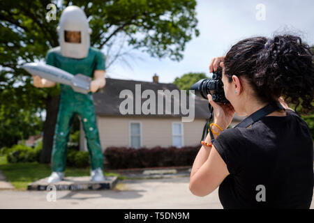 Ypun white woman photographs the Gemini Giant on U.S. Route 66 in Wilmington, Will County, Illinois, USA Stock Photo