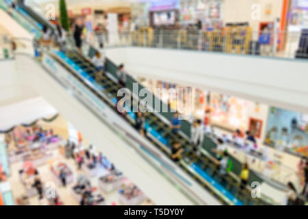 Blurred escalator in in department store with people crowded Stock Photo