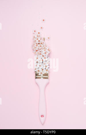 Brush with a trace of pink paint and flower arrangement on white background.  Painting spring creative concept with copy space Stock Photo - Alamy