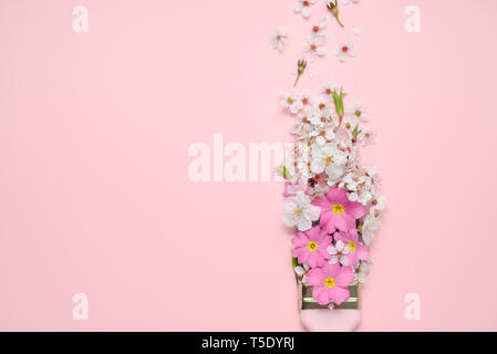 Flowers composition. Paintbrush With Blossoms and pink flowers on pink background. Flat lay, top view, copy space Stock Photo