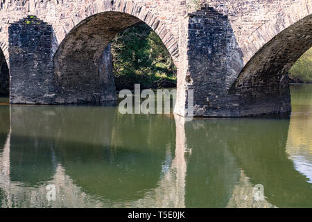 River Reflections and Under Arch Detailed View of Taddiport Bridge on the River Torridge. Stock Photo