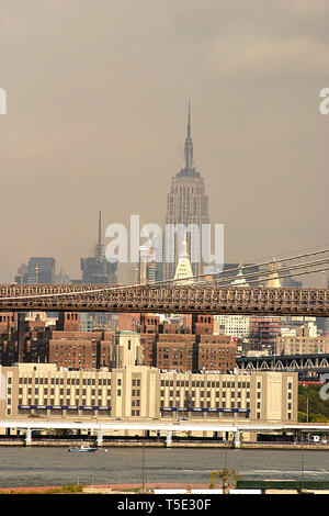 Brooklyn, NYC, USA. On the East River shore with view of the Brooklyn Bridge. In the background, view of  Manhattan, with Empire State Building. Stock Photo