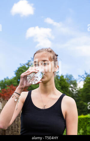 Teenage girl drinking a glass of water Stock Photo