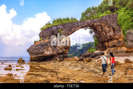 Neil island sea beach Andaman India with natural rock formation and view of couple tourist enjoying a moment in solitude Stock Photo