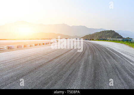 Empty asphalt race track ground and mountains landscape Stock Photo