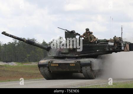 Soldiers from Company B, 1st Battalion, 64th Armor Regiment, 1st Armor Brigade Combat Team, roll back to the front of the range after completing their gunnery table five on April 11, 2019, Fort Stewart, Ga. Gunnery table five is a live fire exercise that tests tank crews on identifying and engaging targets with their weapon systems. Stock Photo