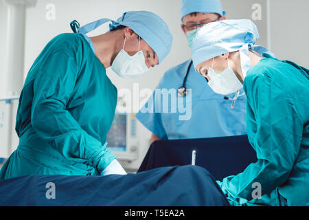 Medical doctors performing operation in hospital Stock Photo